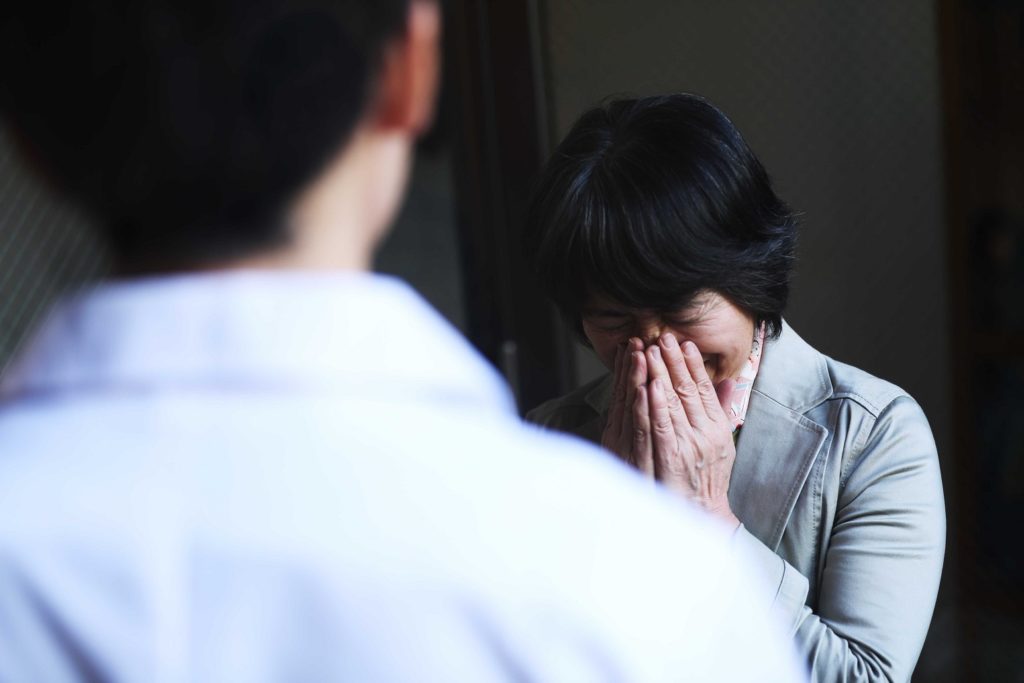 woman crying while speaking with doctor