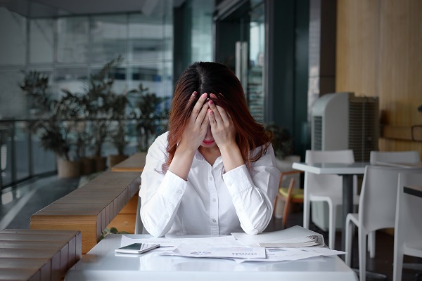 a stressed woman at her desk