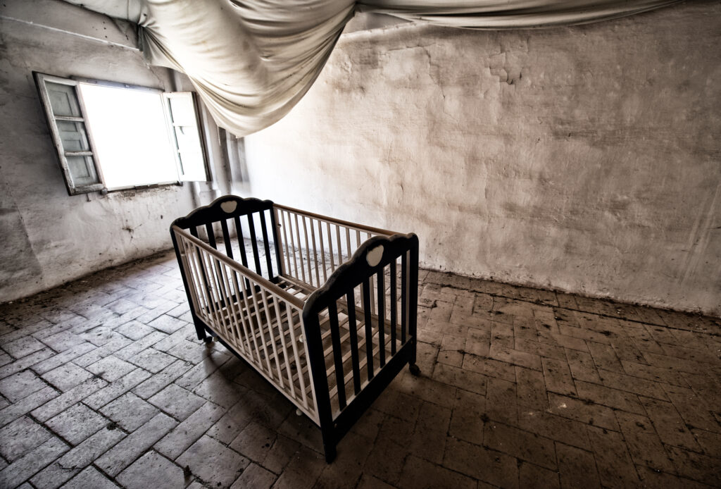 Abandoned bedroom with bay crib